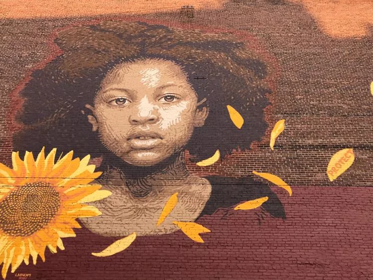 Black child with sunflower mural in Rutland