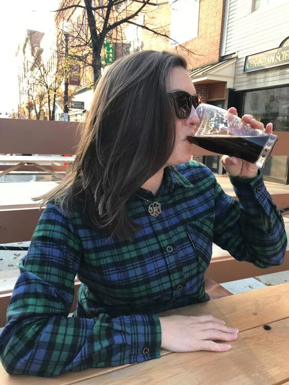 Kat drinking a beer in Rutland - Vermont Road Trip Itinerary Fall