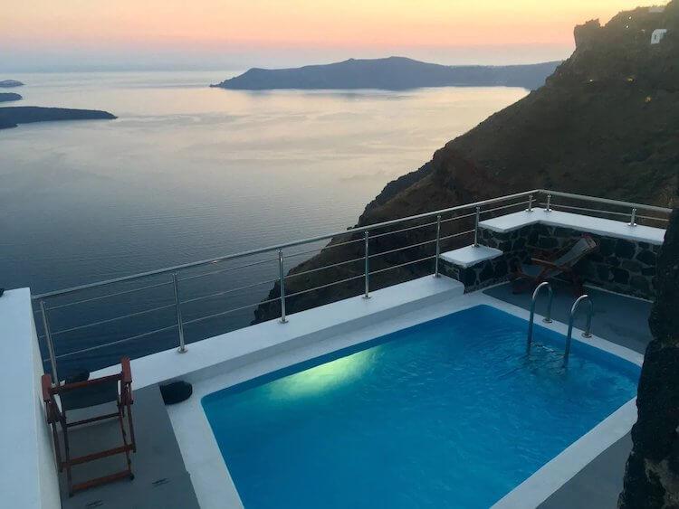 Aegean Sea at sunset in the background with a pool and balcony in the foreground