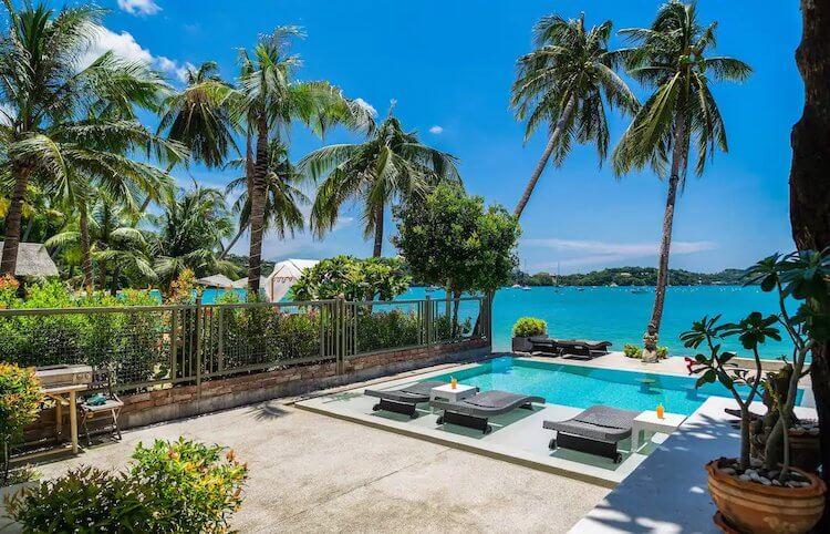 Phuket Thailand Airbnb for Honeymoon with a pool, palm trees, and the ocean in the background