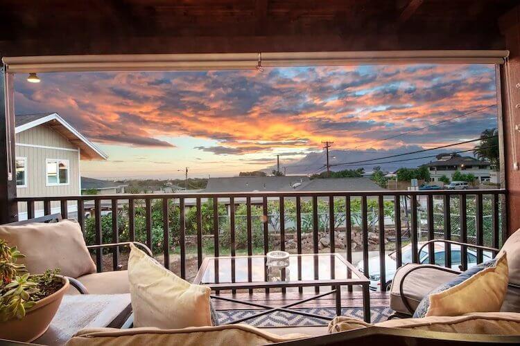 Views of the sunset over the town and mountains in Maui, Hawaii from a luxury Airbnb apartment