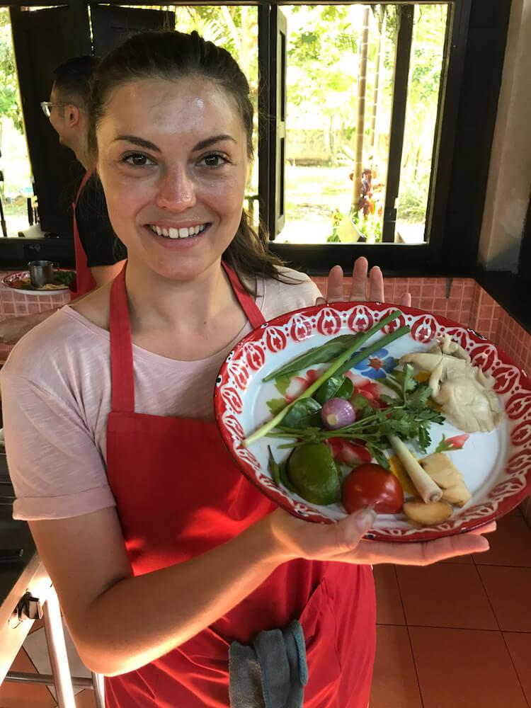 Kat holding the ingredients to make Thai cuisine at Thai Farm Cooking School