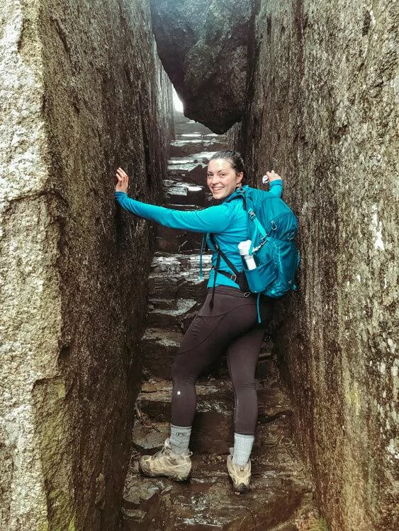 Kat at the base of rock stairs smiling at the camera