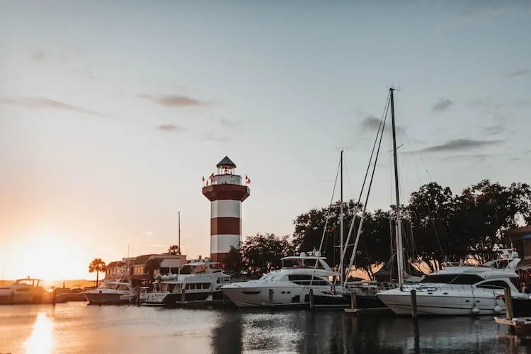 Lighthouse and boats on the water on Hilton Head Island - Best Honeymoon Destinations in the USA