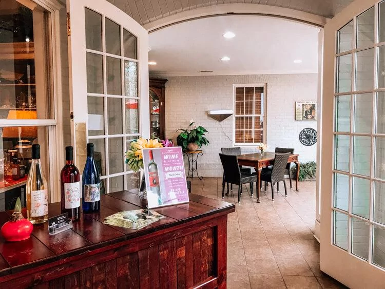 Prince Michel Winery tasting room with wine on display and tables - Best wineries in Shenandoah National Park