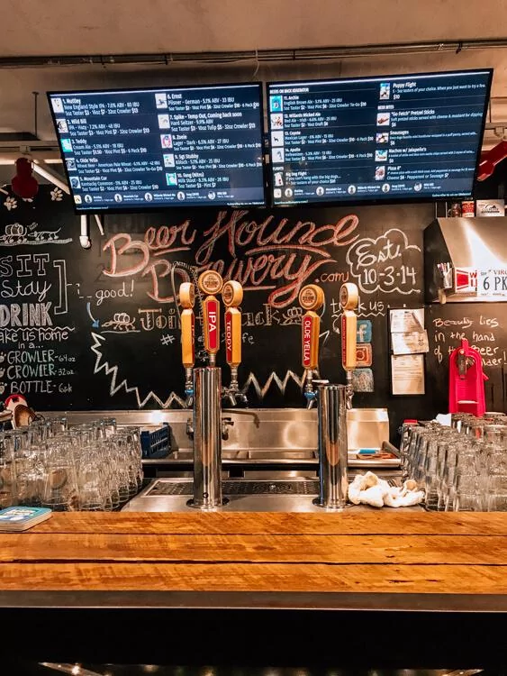 Tap Room with a display of what is on tap and a bar at Beer Hound Brewery