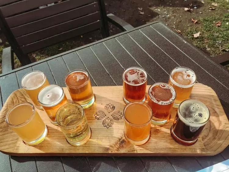 Flight of 10 beers on a wooden plank