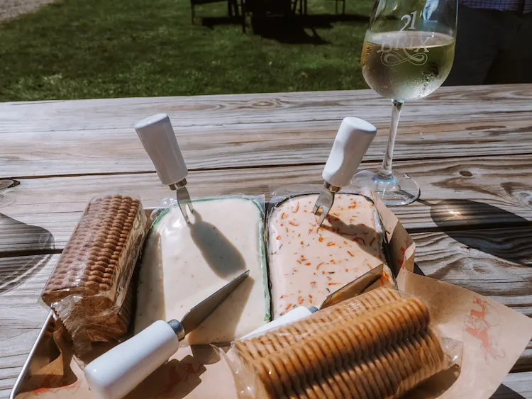 Wine and cheese tray on a picnic table