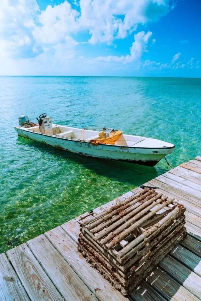 Boat on the water next to a dock in San Pedro Belize