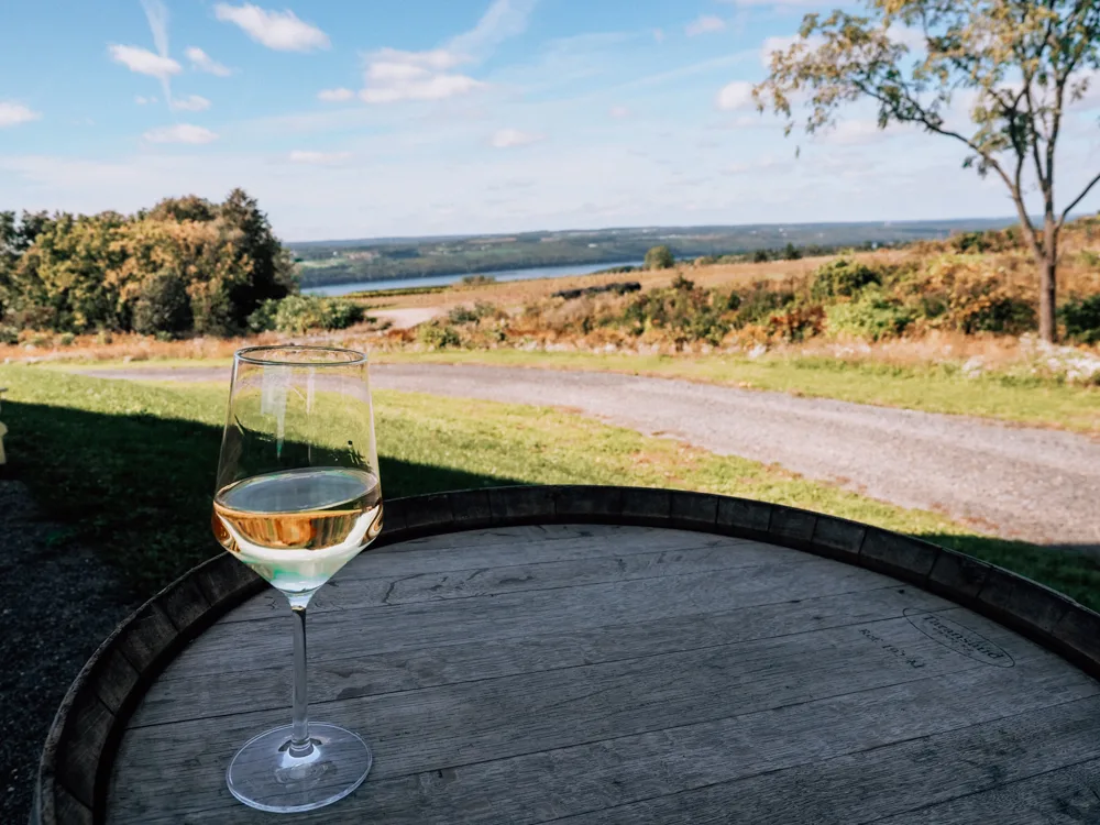 Forge Cellars white wine glass on a barrel top