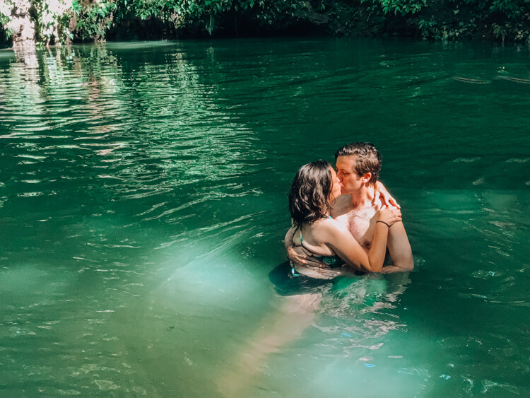 Kat and Chris kissing in a cenote in Belize