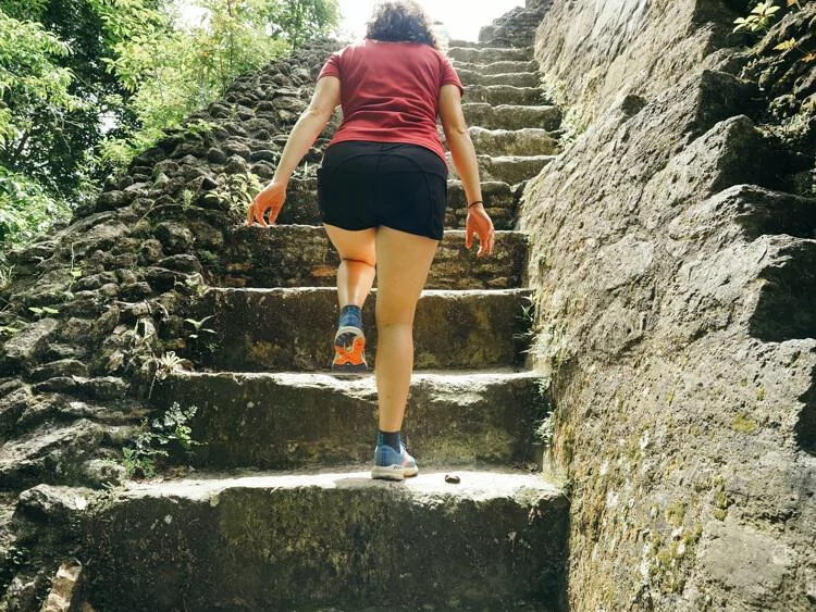 Kat climbing some stairs at Xunantunich