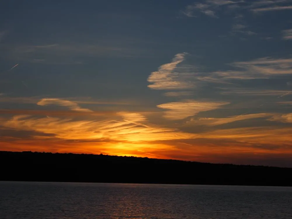 Orange and blue sky over Cayuga Lake at sunset