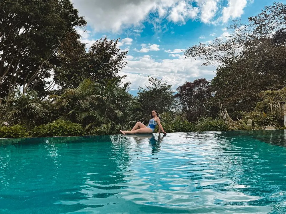 Kat lounging at the pool at Finca Rosa Blanca