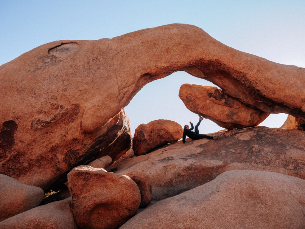 Kat reclining and posing at Arch Rock | Romantic things to do in Joshua Tree