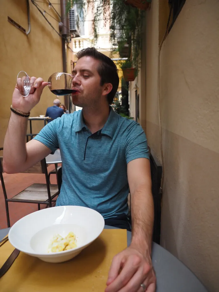 Chris drinking wine in Bologna