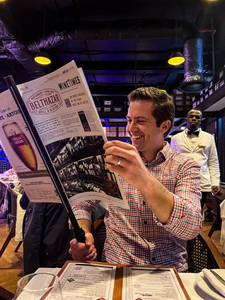 Chris with the wine menu at Balthazar