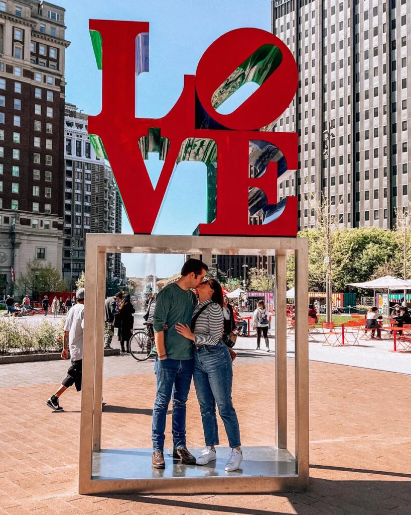 Kat and Chris kissing at Love Park