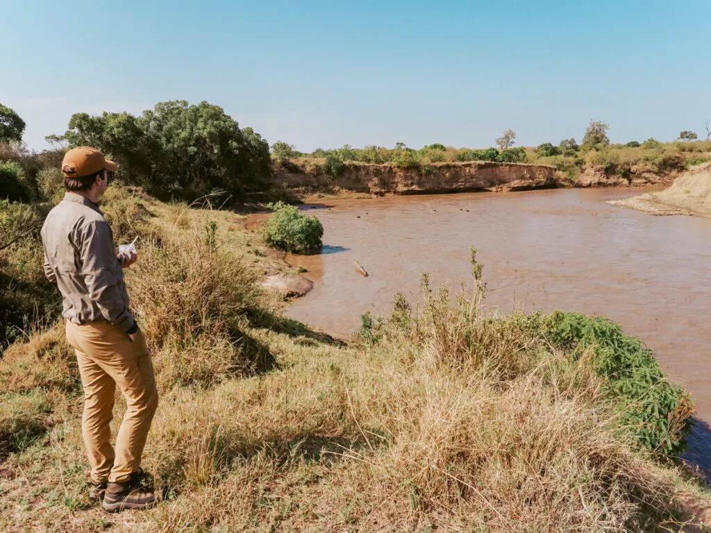 Chris drinking coffee watching the hippos