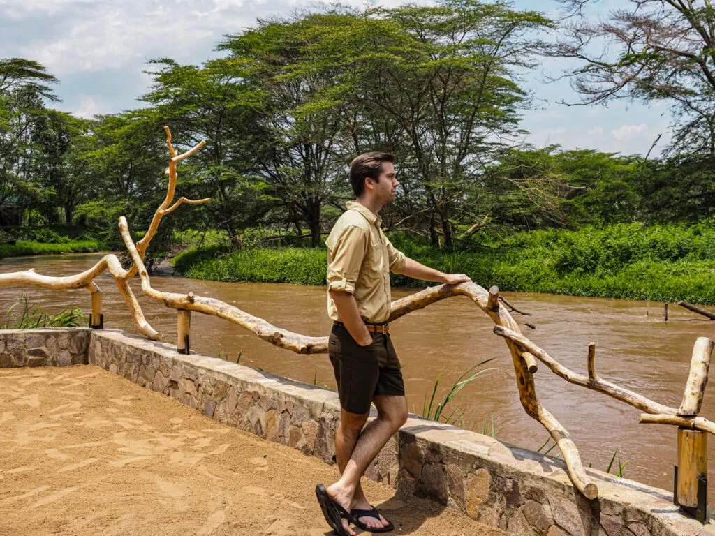 Chris in his safari outfit standing along the river