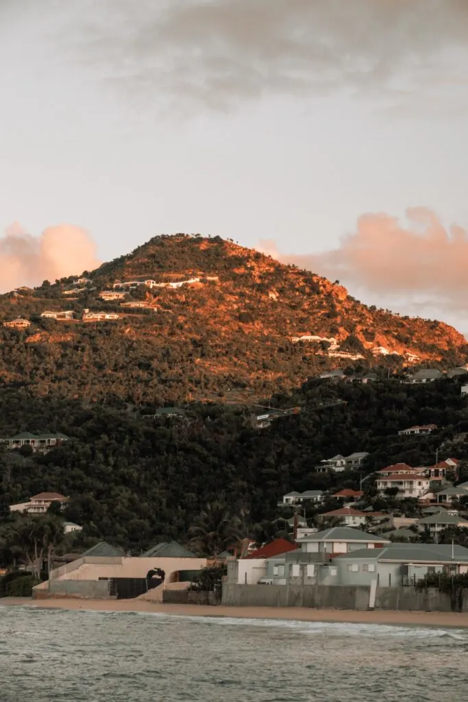 Sunset lit villas in the mountainside from Lorient Beach, St. Barths