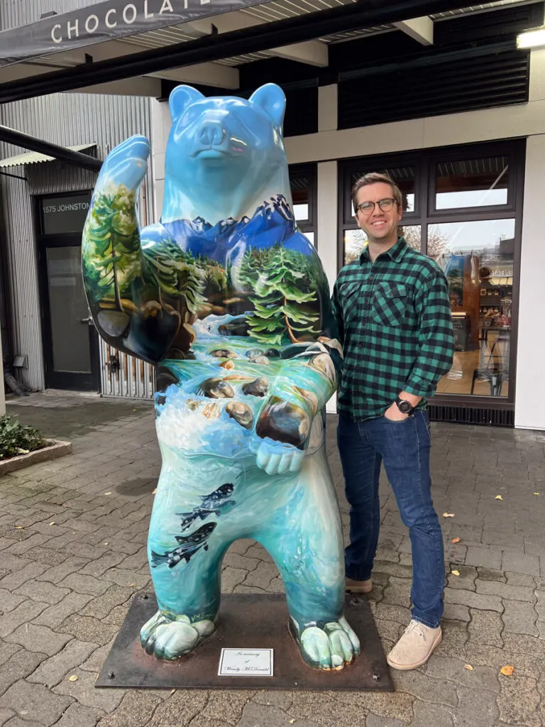 Chris next to a bear statue in Vancouver