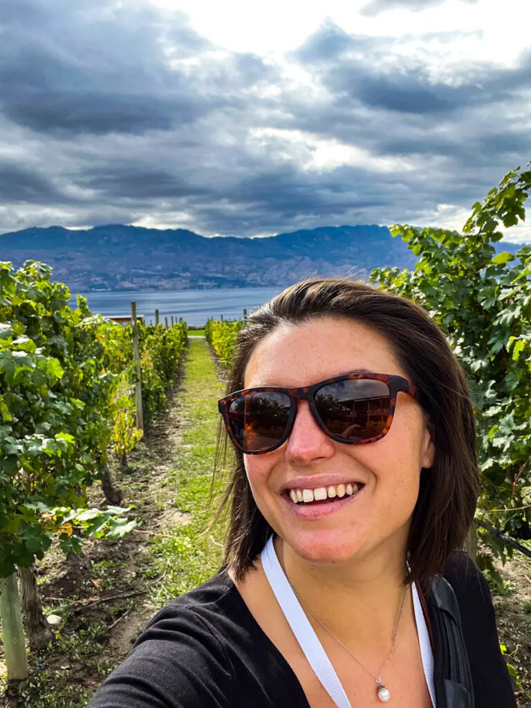 Kat smiling in a vineyard