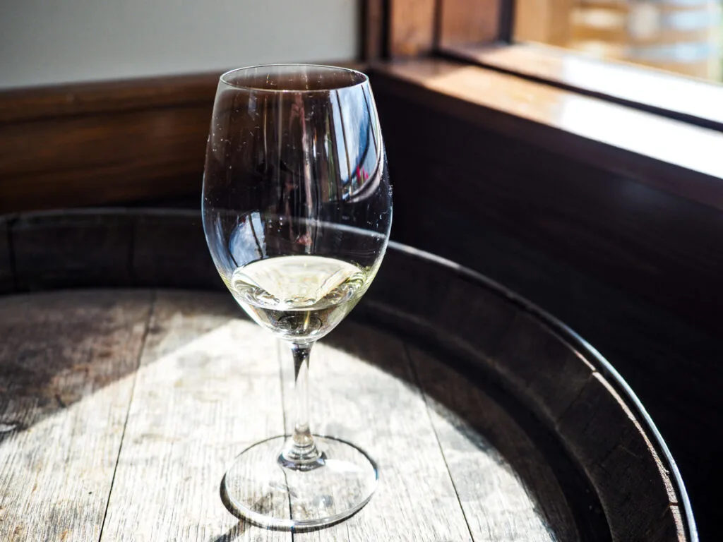 White wine glass on a barrel at Quails Gate Winery
