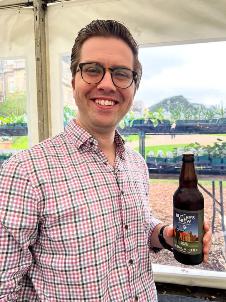 Chris drinking a beer at Highclere Castle