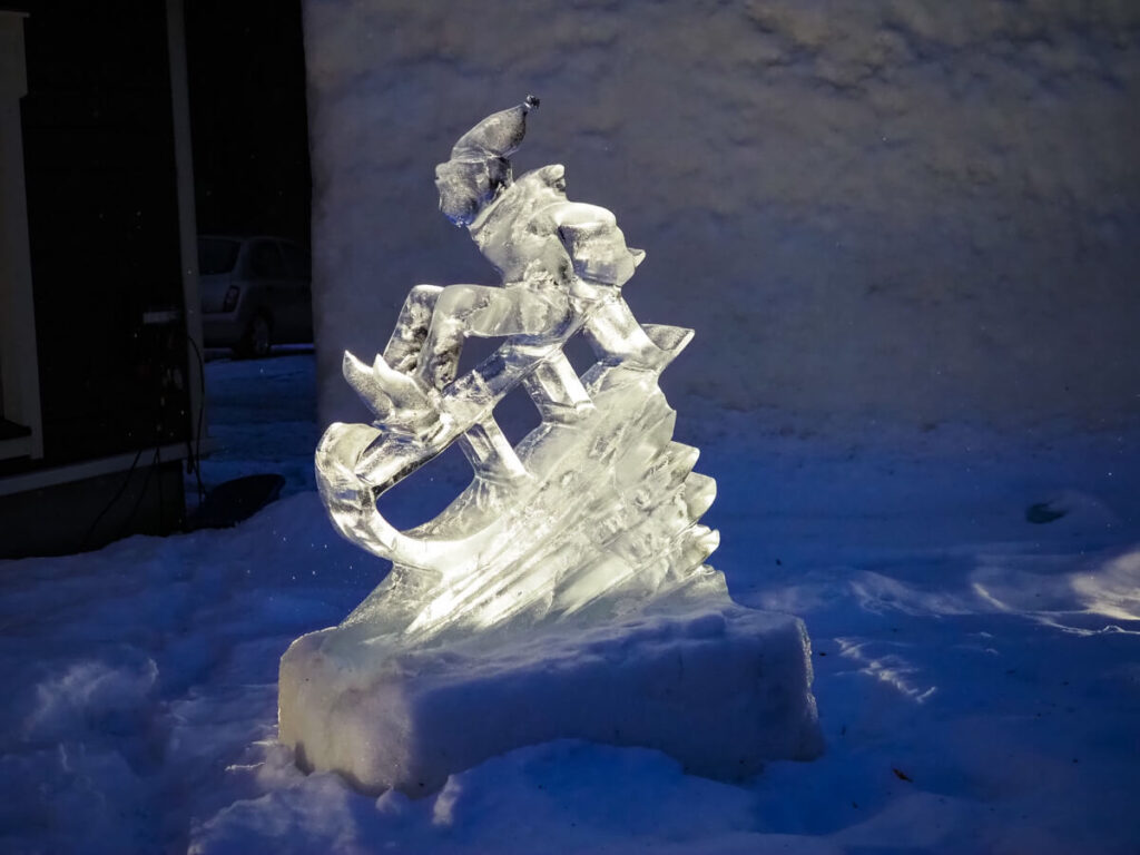 Ice sculpture of an elf sledding at the Arctic SnowHotel