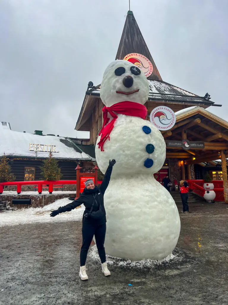 Kat in front of the big snowman at Santa's Village