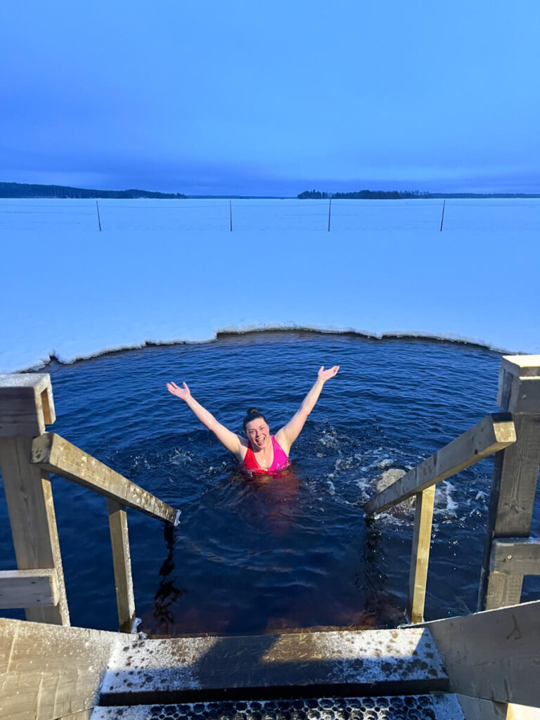 Kat posing in the freezing lake at Apukka Resort
