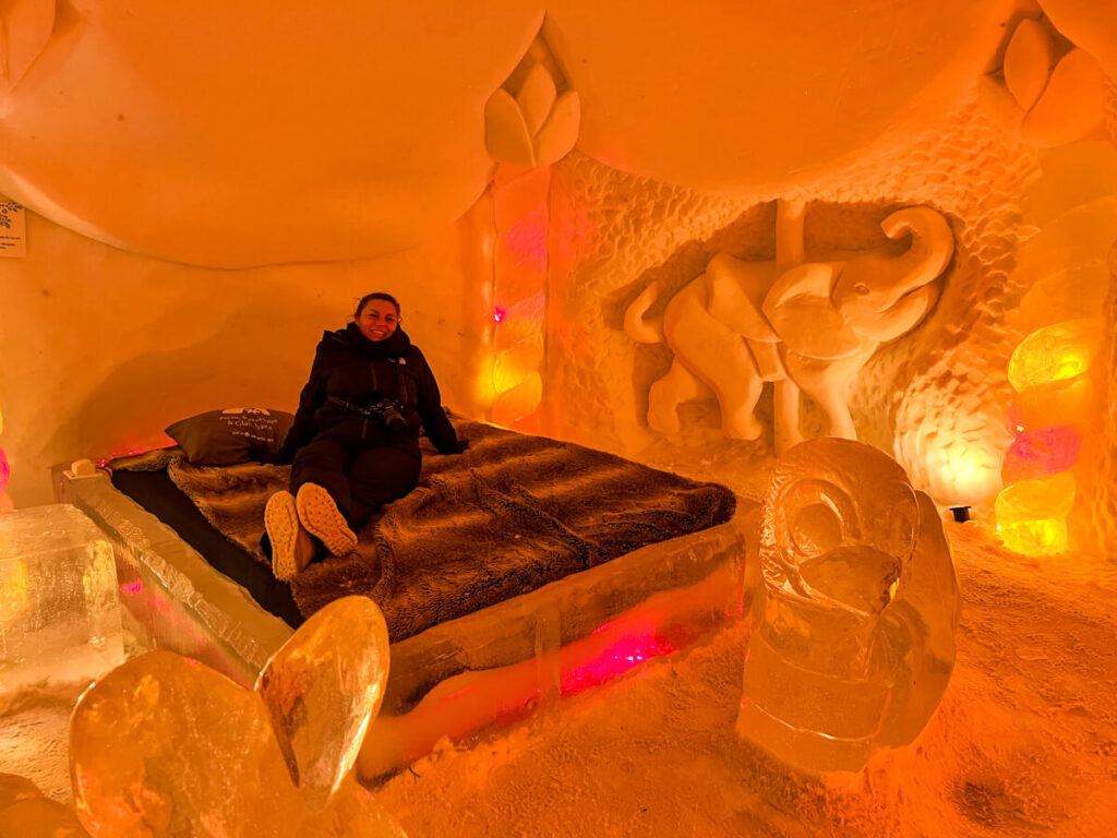 Kat sitting on a bed at the Arctic SnowHotel 2