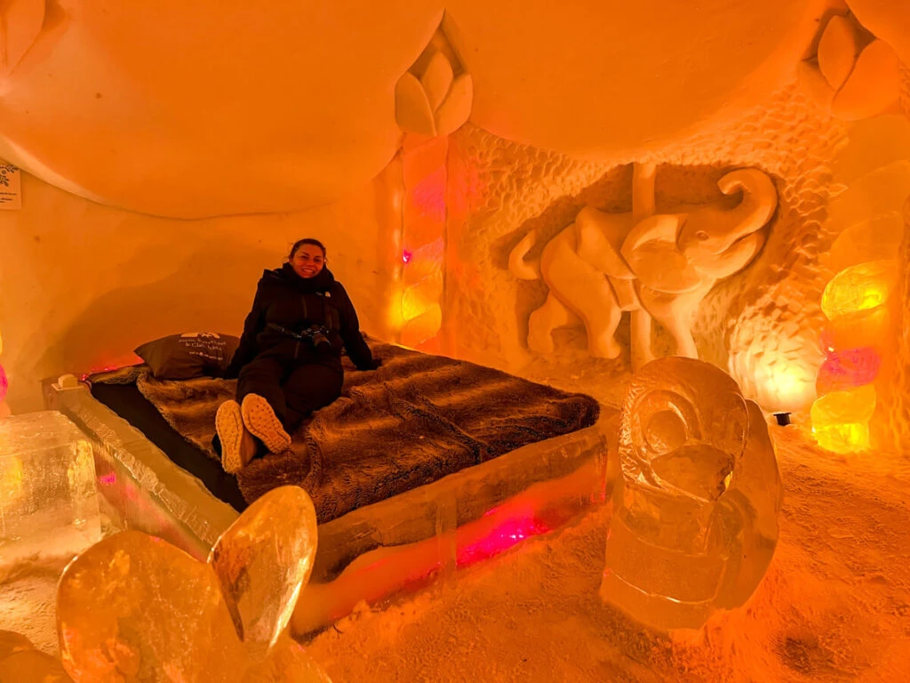 Kat sitting on a bed at the Arctic SnowHotel 2