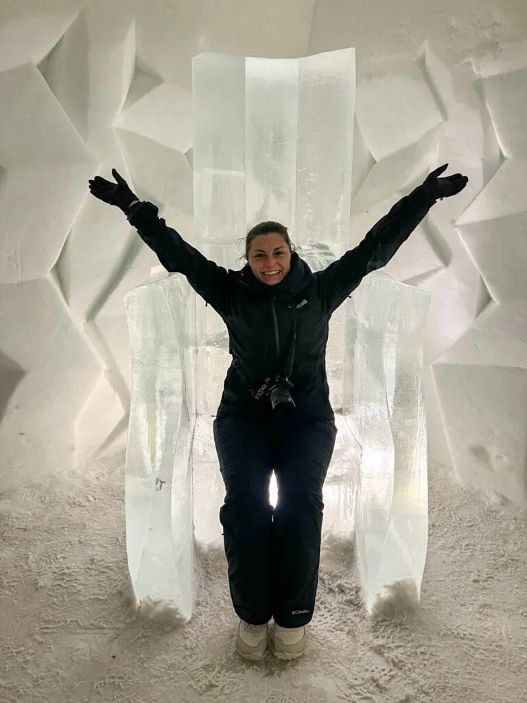 Kat sitting on an ice throne at the Arctic SnowHotel