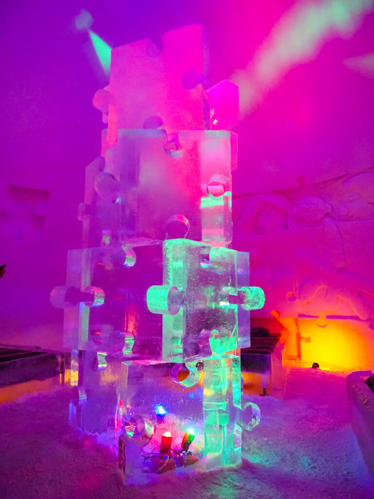 puzzle ice sculpture with pink and green colors at Arctic SnowHotel