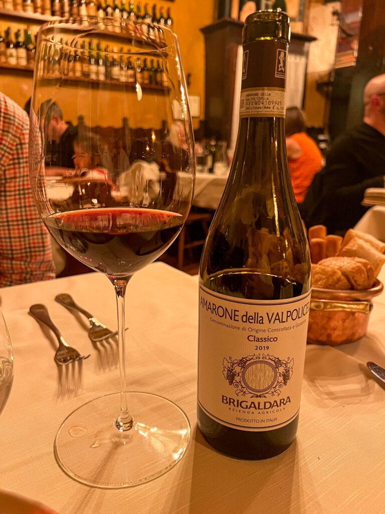 Amarone bottle and glass with wine at Antica Bottega del Vino