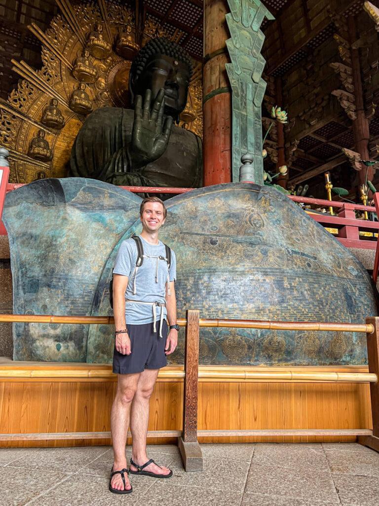 Chris standing next to a replica bronze lotus leaf of the Diabatsu of Nara for size comparison